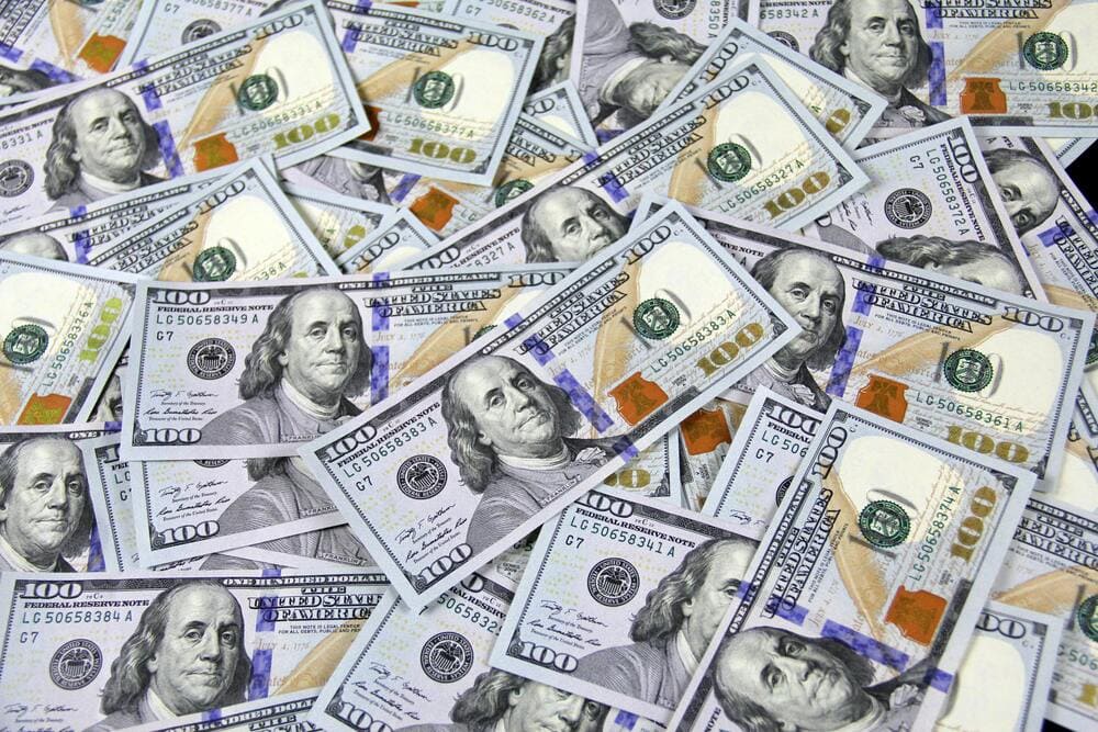 100 dollar bills in a pile
