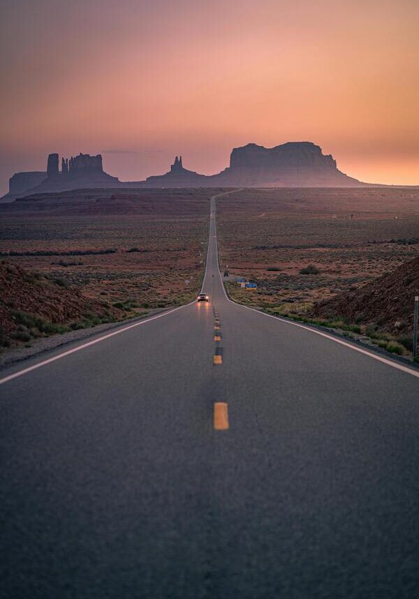 Open Road Vertical image of an empty two lane highway with mountains in the background